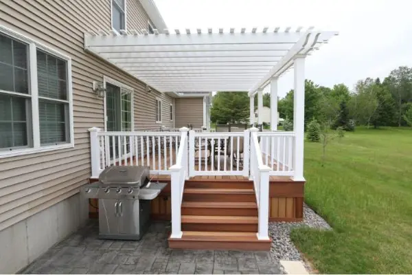 wooden outdoor deck with white pergolas