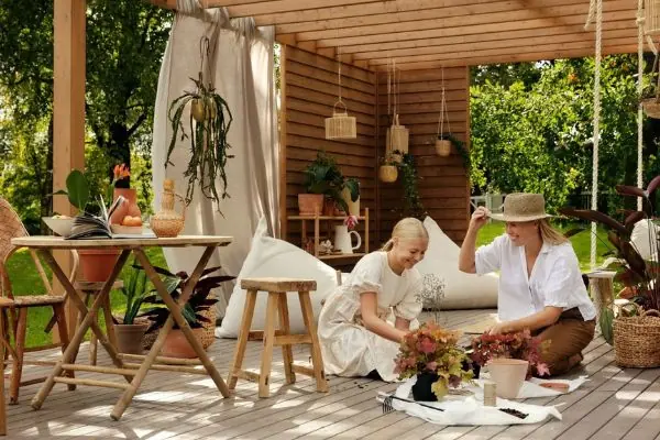 two woman decorating pergola and deck