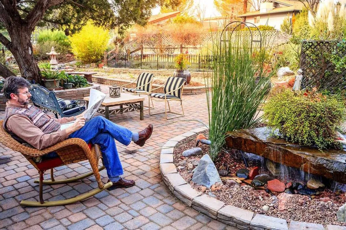 women reading news paper in hardscape patio