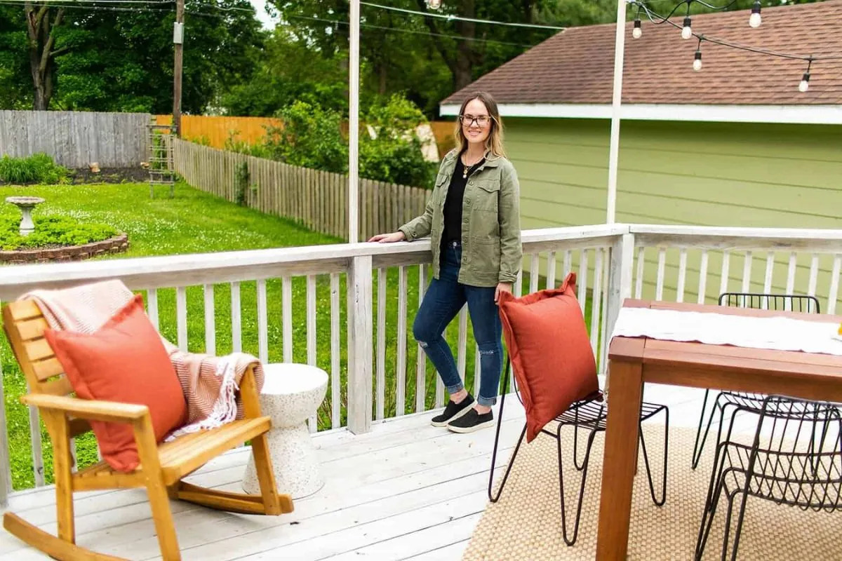 women standing in back porch of house