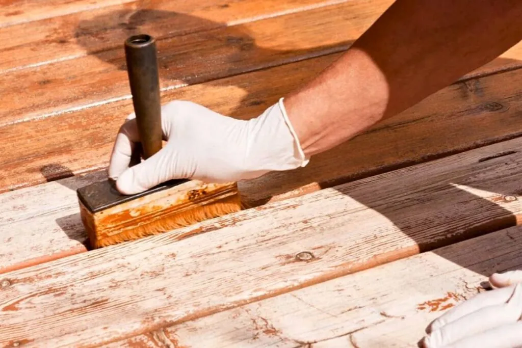 man hand holding tools for deck floor resurfacing